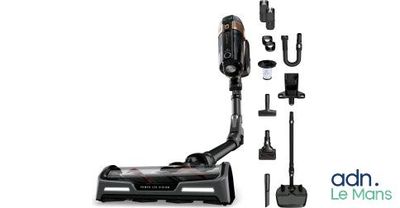 a black and white photo of a vacuum cleaner and accessories