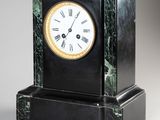a black and gold clock with roman numerals on it