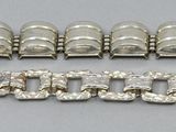 two pieces of silver bracelets and a bracelet with a clasp
