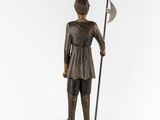 a bronze statue of a man with a spear and shield