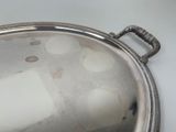 a silver plate with holes in it on a table
