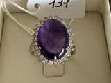 an image of a purple stone ring in a box with a price tag