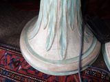 a close up of a vase with a cell phone on it