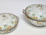 two porcelain dishes with handles and handles on a white surface