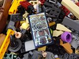 a large pile of legos and a cell phone in a box