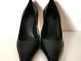 black high heel shoes on a white surface