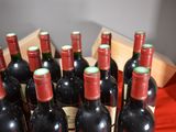 many bottles of wine in a wooden crate on a table