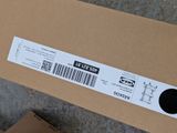 a cardboard box with a sticker on it sitting on the ground