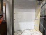 an empty refrigerator in the middle of a room