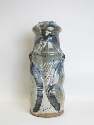a blue and white vase sitting on a white surface