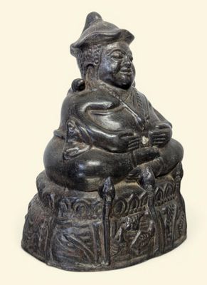 une petite statue représentant un homme assis sur un tabouret