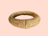 a ring that is made of stone on a pink background