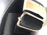 a close up of a black belt with a gold buckle