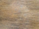 a close up view of a wooden surface with some stains on it