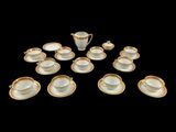 many cups and saucers that are arranged in the shape of a heart