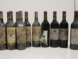 several bottles of wine are lined up in a row on a table