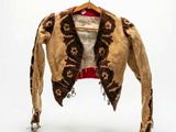 a brown jacket hanging on a clothes rack with a white background