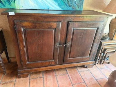 a painting on the wall above a cabinet in a room