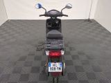 a motor scooter parked in a room with a checkered floor