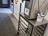 an image of a coffee machine on a cart in a coffee shop