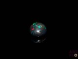 an image of a black oplite sphere in the dark