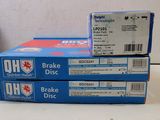 boxes of brake discs stacked on top of each other on a table