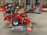 an image of a small red machine in a warehouse