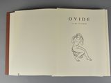 an open book with a drawing of a woman sitting on a chair