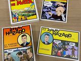quatre bandes dessinées sont posées les unes à côté des autres sur une table