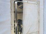 a mirror hanging on the wall next to a bed