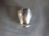 a silver cup that is sitting on a table