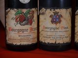 three bottles of wine sitting on top of a table next to each other