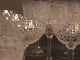 many wine glasses lined up on a table