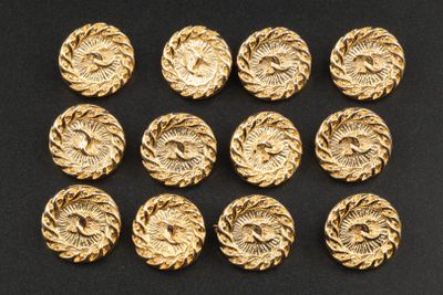 a set of nine gold tone buttons with a flower design