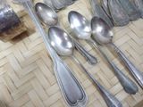 many spoons and spoon spoons sitting on a table