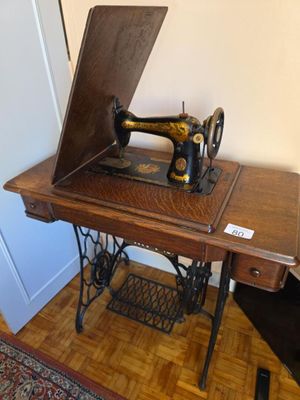 an old sewing machine sitting on a table in a room