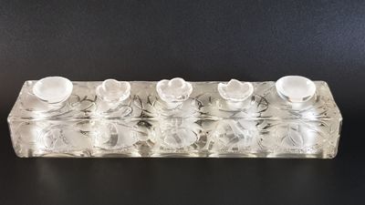 an image of a clear glass candle holder with four candles