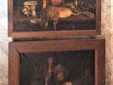 two paintings on the wall of a room with a cat and a dog
