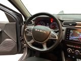 the interior of a car with a steering wheel and dashboard controls