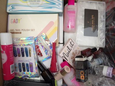 a lot of nail polish and cosmetics items in a box