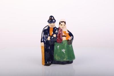 a figurine of a man and a woman sitting on a chair