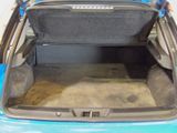 the back of a car with the trunk open and the seat folded down