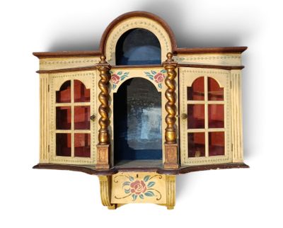 a wooden cabinet with a glass door and a window