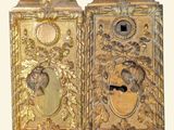pair of antique brass door handles with ornate designs on each side