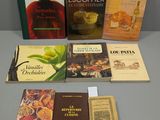 Plusieurs livres sont posés sur une table devant un mur gris.