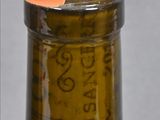 a close up of a bottle of wine with a cork in it