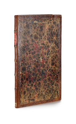 an old book with a brown cover and a red and black design