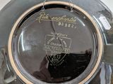 a close up of a black plate with writing on it