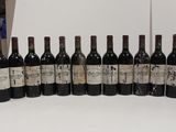 several bottles of wine are lined up in a row on a table