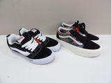 two pairs of black and white vans style sneakers on a white surface